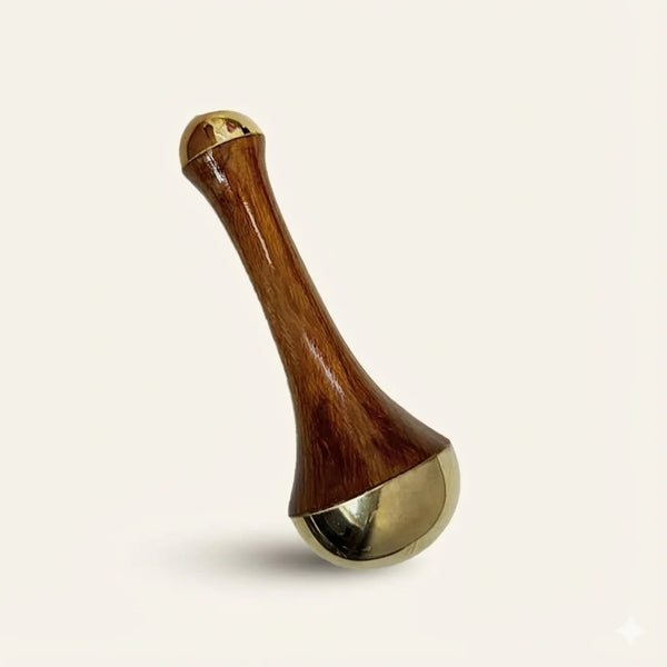 Wooden and Bronze Face Massager on a beige background
