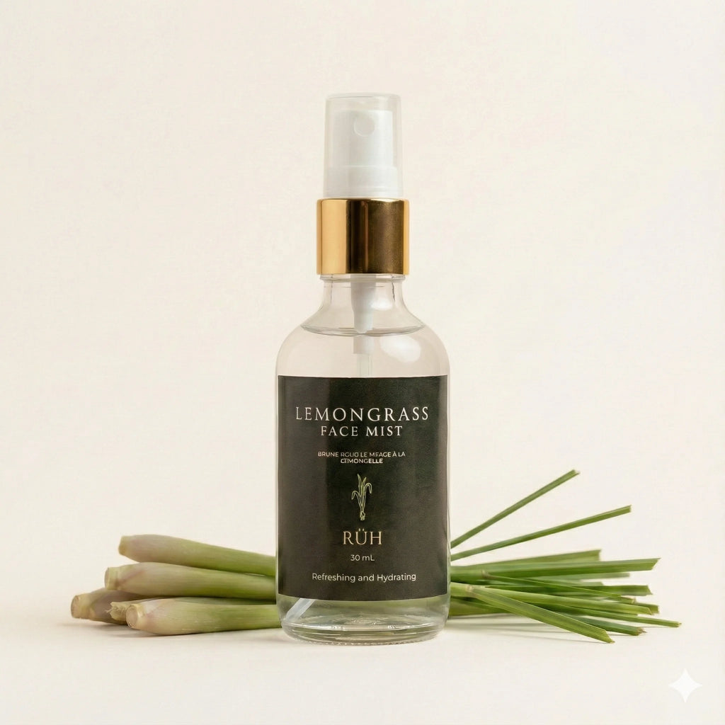 Bottle of Lemongrass Face Mist with lemongrass leaves on a light background