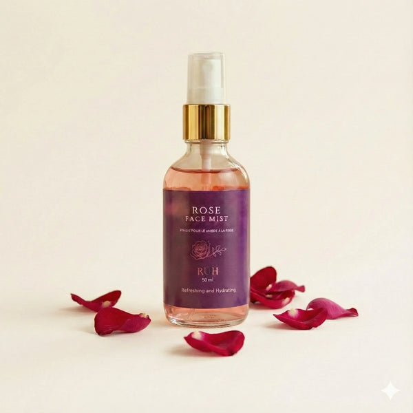Rose face mist bottle with red rose petals on a beige background