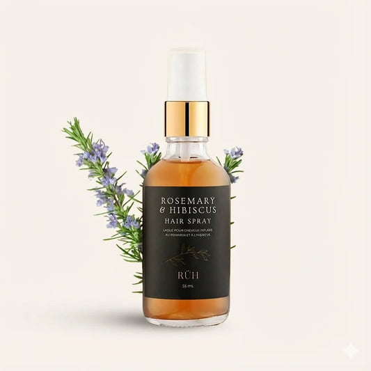 Rosemary & Hibiscus hair spray bottle with gold cap on a light beige background