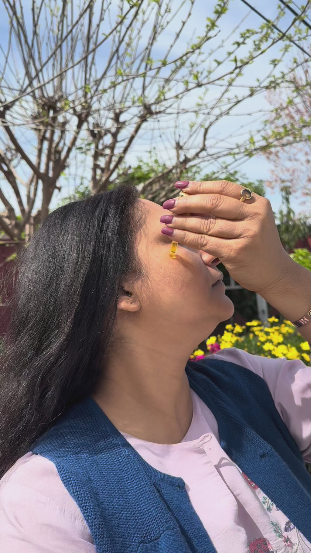 A woman applying Saffron Face Oil on her face
