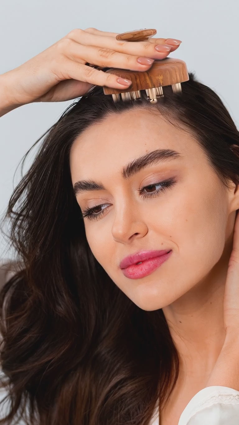 Video of a woman using Kansa Head Massager on her head.